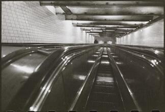 Life and Love on the New York City Subway [Escalators in a subway station.]