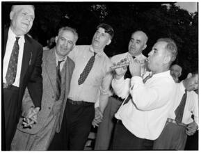 [Man playing a pipe.]