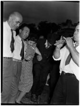 [Group dancing while a man plays the pipe.]