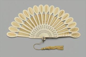 Folding fan of yellow silk and ivory