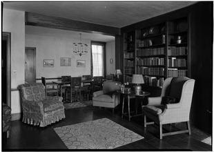 Gertrude Hochschild [residence]. Living room books & dining room.