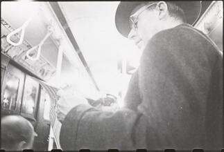 Life and Love on the New York City Subway [Man riding a subway.]