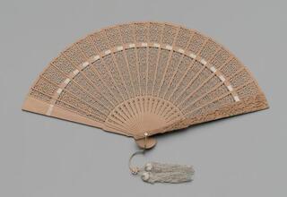 Folding fan of pierced and carved sandalwood with original box