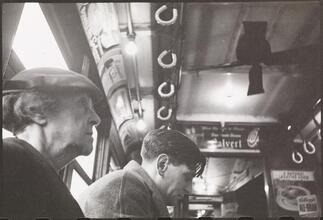 Life and Love on the New York City Subway [Men riding a subway.]