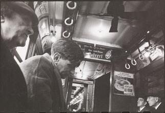 Life and Love on the New York City Subway [Men riding a subway.]