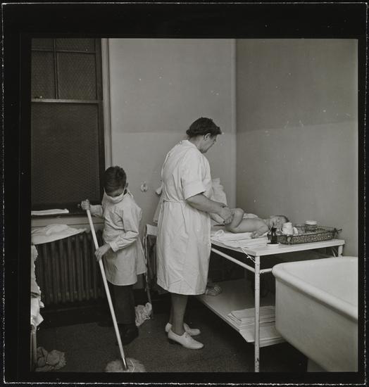 Museum of the City of New York - Orphanage [Nurse changing a diaper ...