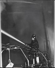 [Fireman watching burning building.]