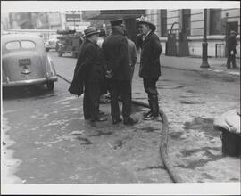 [Big Brass talk over condition of firemen injured and the cause at the West 50th Street fire.]