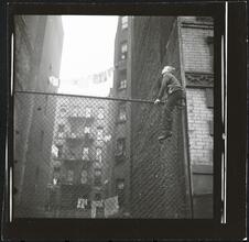 Shoe Shine Boy [Mickey climbing a fence.]