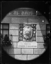 University Club seal on building wall.