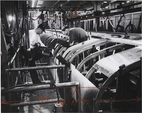 [Men building railroad cars.]