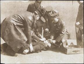 [Firemen performing first aid.]