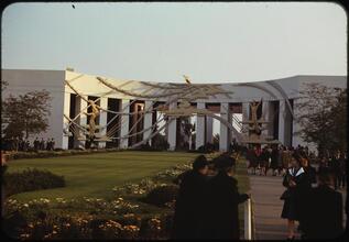 [People by the "Time" sculpture in front of the Business Systems and Insurance Building.]