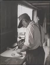 [Man shucking clams.]
