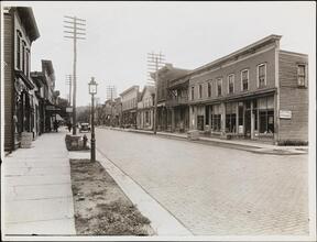 [Street with stores.]
