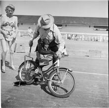 Circus [Monkey riding a bicycle.]