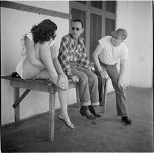 Circus [Group of people talking outside a building.]
