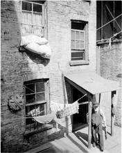 Tenement Rear with Man in Doorway