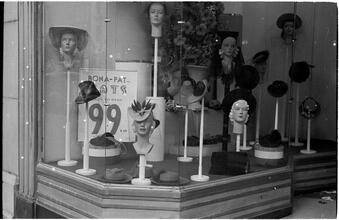 [Hat displays in store window.]