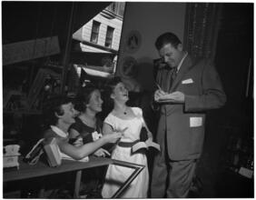 [Jack Carson signing autographs.]