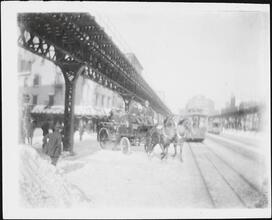 [Horse-drawn carriage under the El Train.]