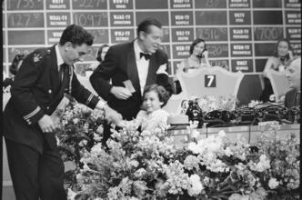 Milton Berle - Damon Runyon Cancer Fund [Girl on stage with Milton Berle and another man at the telethon.]