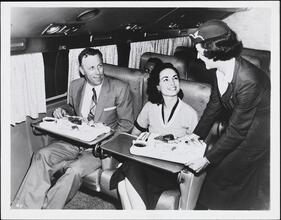 [Passengers and flight attendant on a Eastern Airlines flight.]