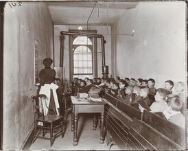East Side Public Schools 1. A class in the condemned Essex Market School, Gas burning by day.