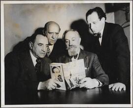 [Maurice Schwartz, Joseph Rumshinsky, Zalman Schneour, and David Licht holding a copy of "Song of the Dnieper".]