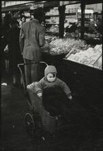 The 5 and 10 [Child in a stroller at Woolworth's.]