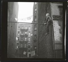 Shoe Shine Boy [Mickey climbing a fence.]