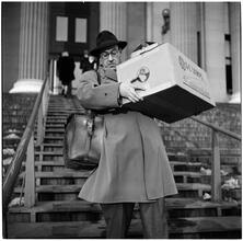 Columbia University [Man carrying a box down stairs.]