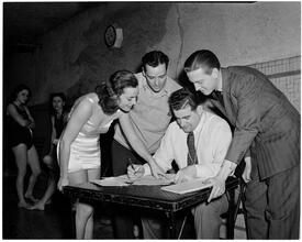 Holm, Eleanor- World's Fair N.Y. Swimming Pool [Eleanor Holm with a group of men.]