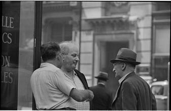 Street Conversations [Three men talking on the street.]