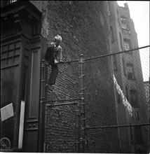 Shoe Shine Boy [Mickey climbing a fence.]