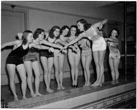 Holm, Eleanor- World's Fair N.Y. Swimming Pool [Eleanor Holm, with students, demonstrating a swimming stroke.]