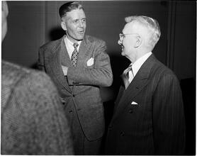 Dale Carnegie [Dale Carnegie talking to a man.]
