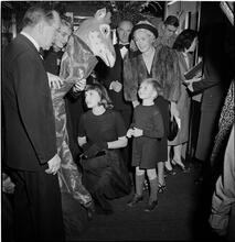 United Nations Children's Party [Child playing with someone in a giraffe costume.]