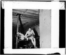 Lodger in Pell Street 7 cents lodging house (Happy Jack's Canvas Palace) going to bed.