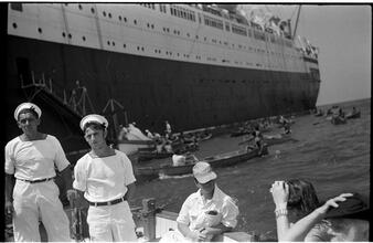 [Boats leaving ocean liner.]