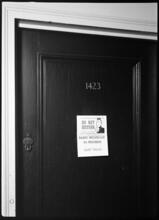[Interior, entrance to radio broadcast room.]