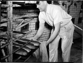 [Man baking bread.]