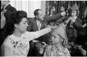 Deaf Children [Teacher putting a party hat on a child.]
