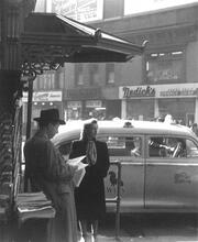 Untitled [Couple by magazine stand, with cab in background, Union Square]