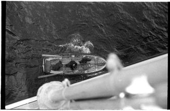[Rowboat next to ship.]