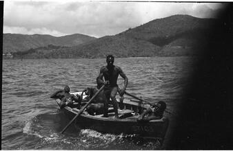 [Man rowing boat in the Caribbean.]