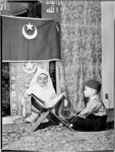 [Muslim cleric with a small boy.]