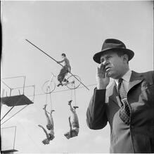 Circus [Balancing act with trapeze artists.]