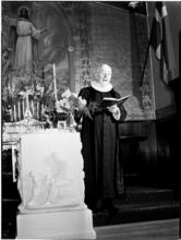 [Priest at an altar.]