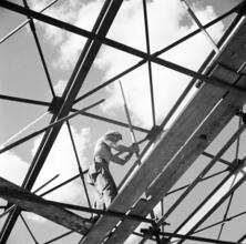 [Man working at the New York World's Fair construction site.]